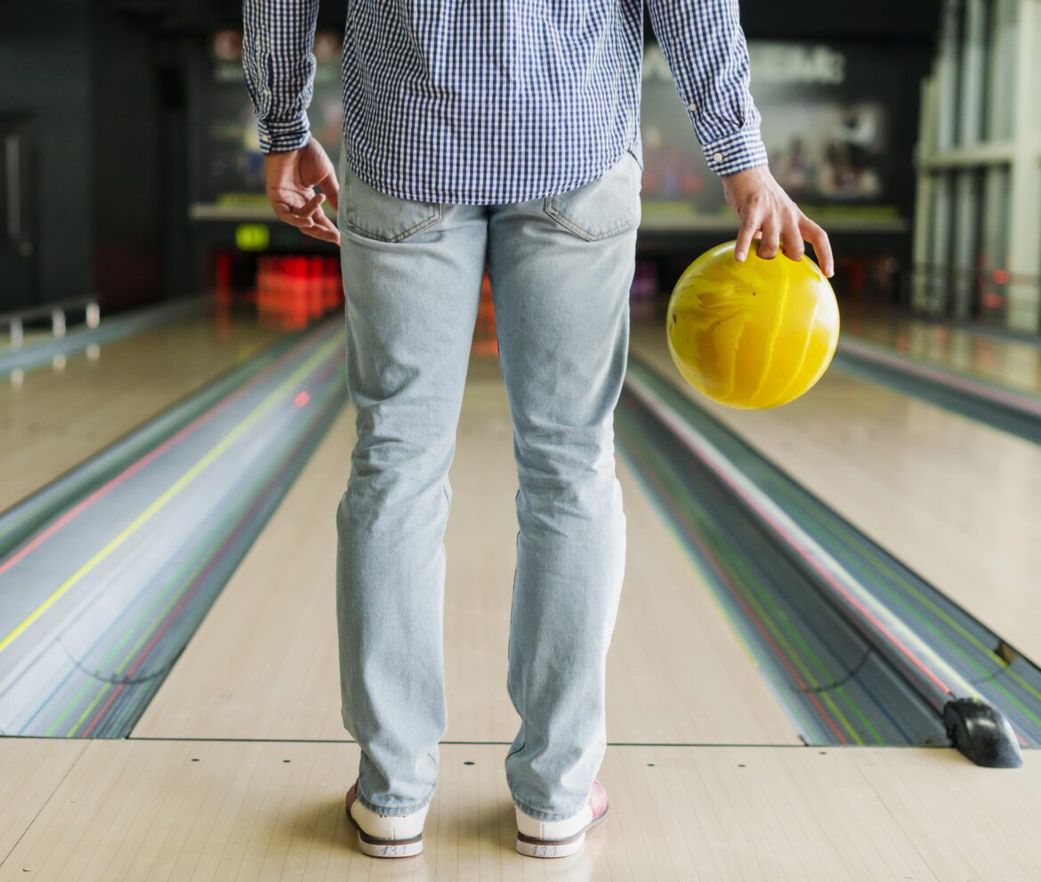person-holding-bowling-ball-min person holding bowling ball